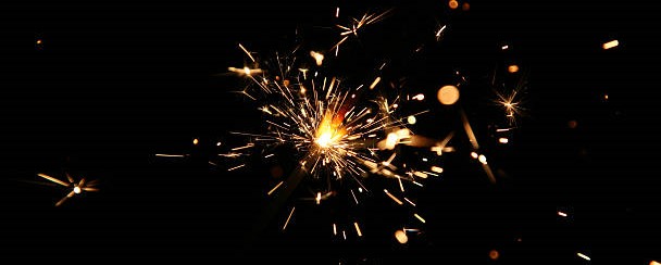 Sparks fly against a dark background
